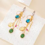 Pair of colorful glass and pearl chain tassel earrings laid flat