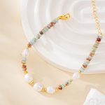 Close view of pastel stone beads and irregular pearls on an adjustable bracelet