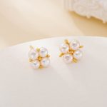 Four round freshwater pearls arranged in flower-like stud earrings