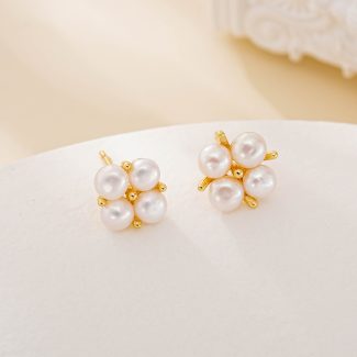 Four round freshwater pearls arranged in flower-like stud earrings