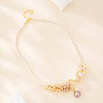 Three-color baroque pearl statement necklace with clustered blush pearls and lilac pearl drop