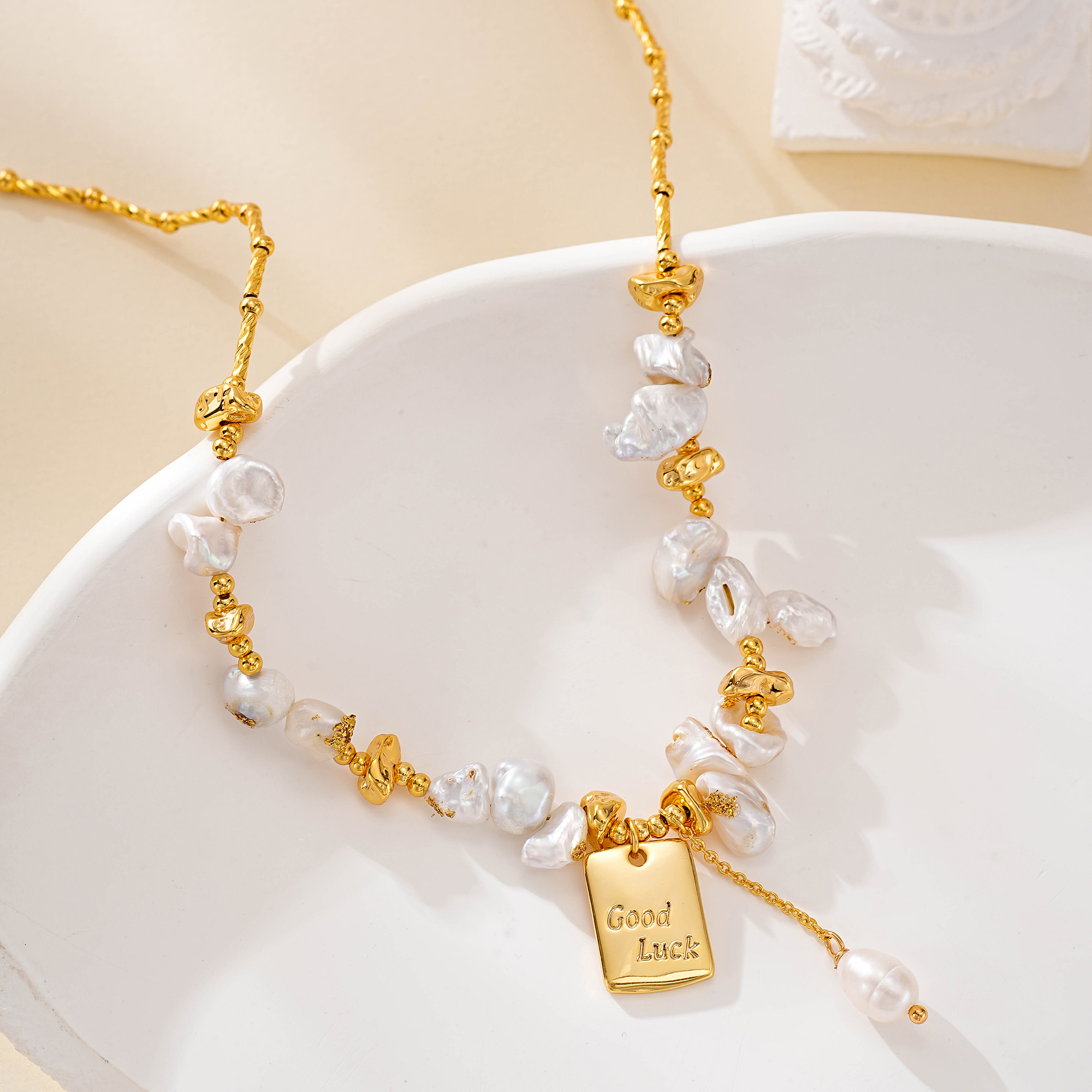 Good Luck charm hanging beneath clustered baroque pearls