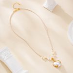 Full pearl-accented necklace with sculptural pendant on a fine chain