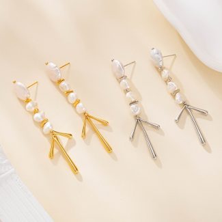Gold-tone and silver-tone baroque pearl chandelier earrings side by side