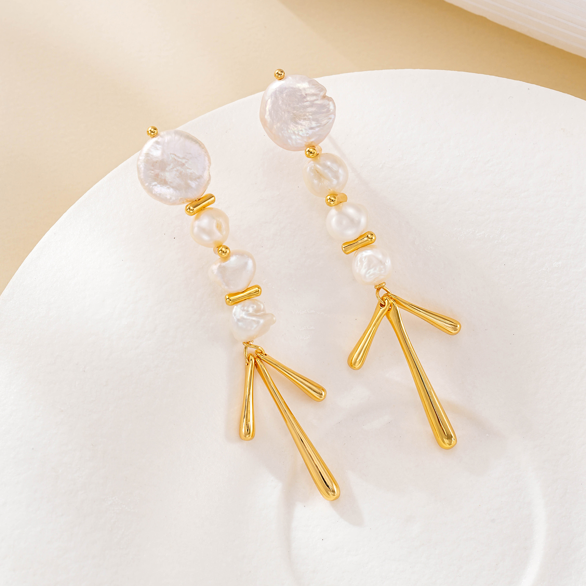 Gold-tone baroque pearl chandelier earrings with three tapered drops