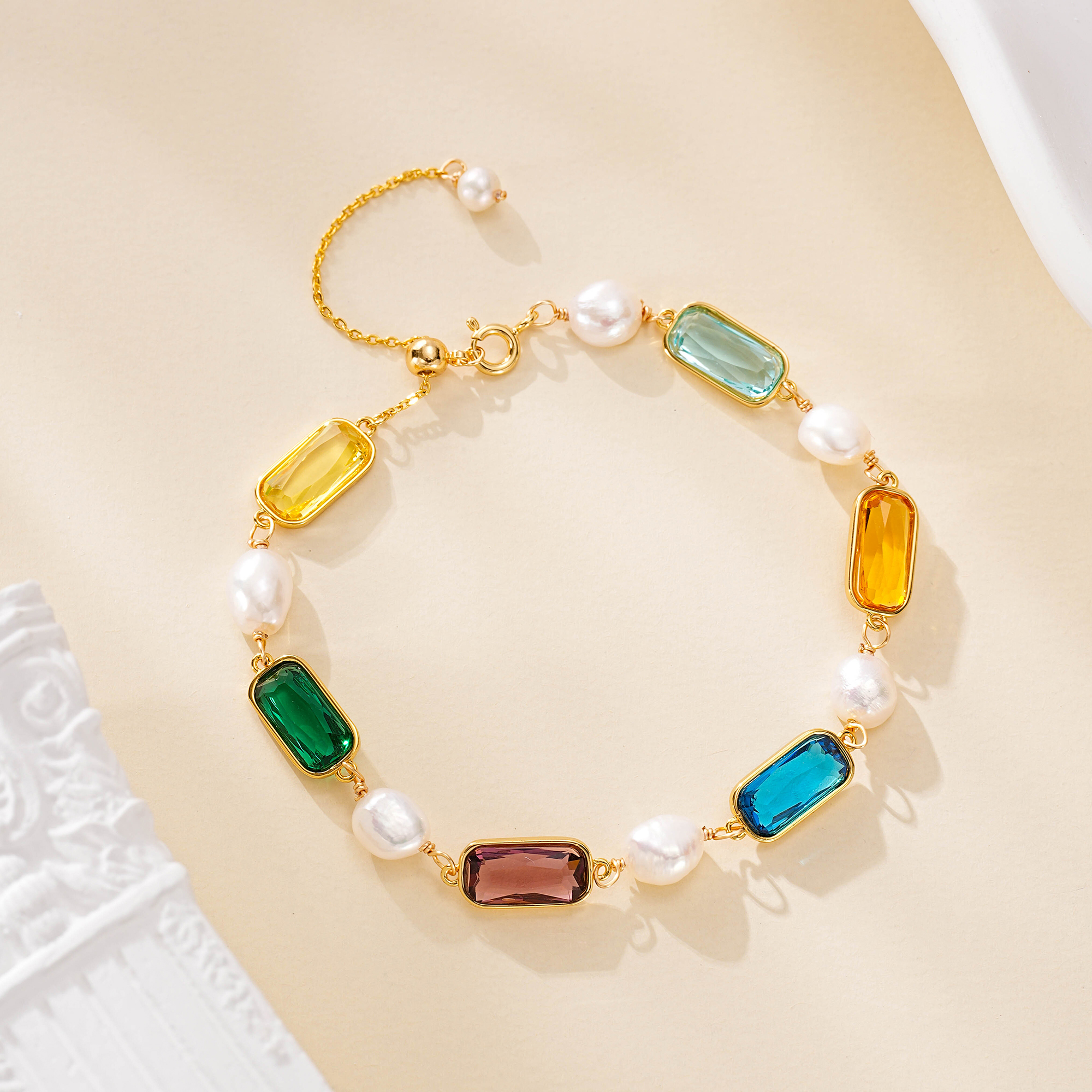 Multicolor gemstone bracelet with pearls and a gold-tone chain