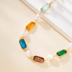 Close-up of rectangular colorful stones and pearls on a bracelet