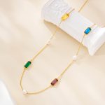 Multicolor gemstone necklace draped over a white sculptural display