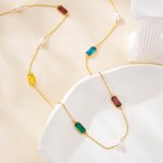 Gemstone and pearl necklace arranged in a loose loop