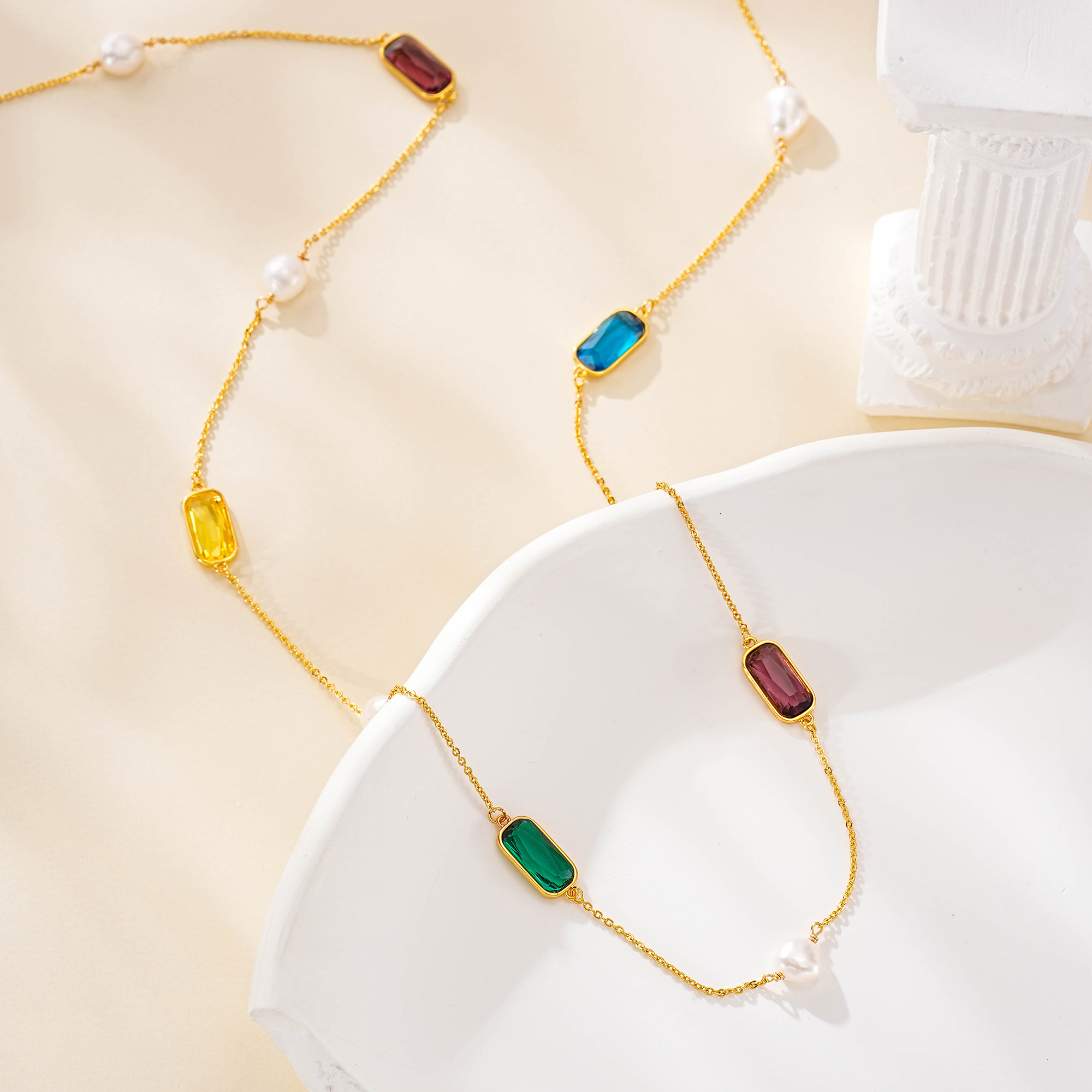 Gemstone and pearl necklace arranged in a loose loop
