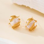 Baroque pearl and wheat-detail stud earrings viewed from the side