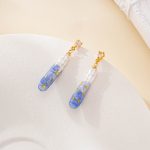 Close-up of painted blue pearl drop earrings with stud posts