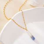Close-up of delicate chain and painted pearl pendant