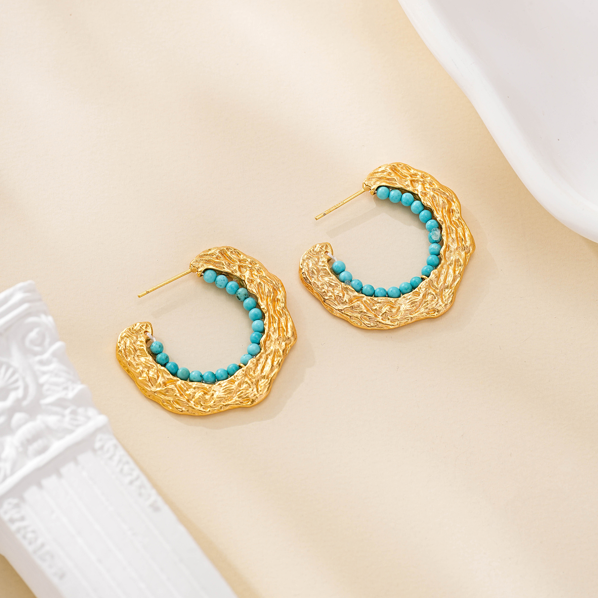 Textured gold-tone C-hoop earrings lined with turquoise beads