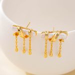 Pair of pearl bar earrings with triple chain tassels
