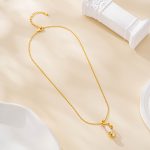 Gold-tone chain necklace with spiral-wrapped pearl pendant
