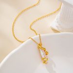Baroque pearl pendant framed by a sculptural gold-tone spiral