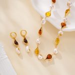 Amber-toned resin and pearl earrings with matching necklace