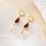 Close view of resin teardrop and pearl hoop earrings