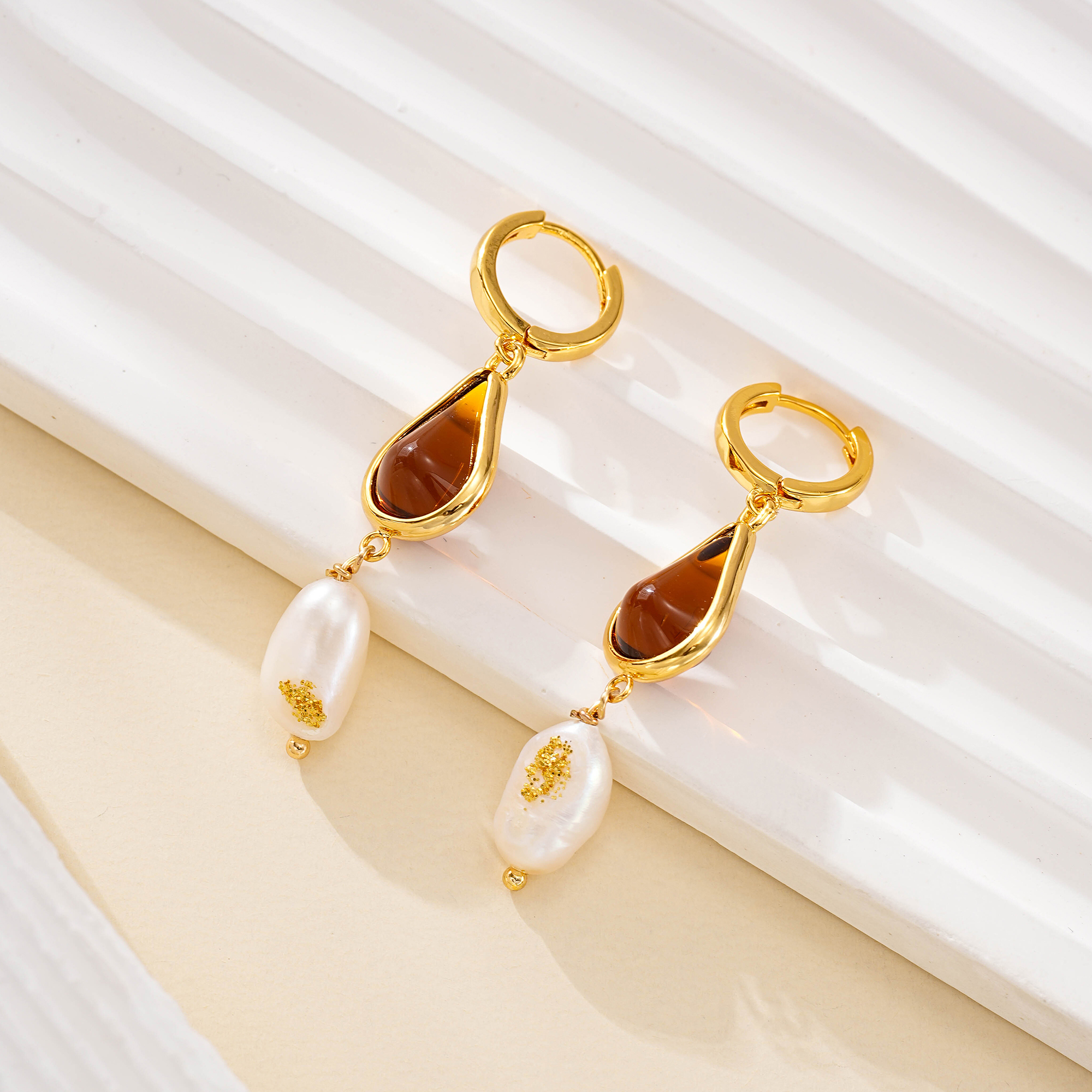 Pair of amber-toned resin earrings with pearl drops