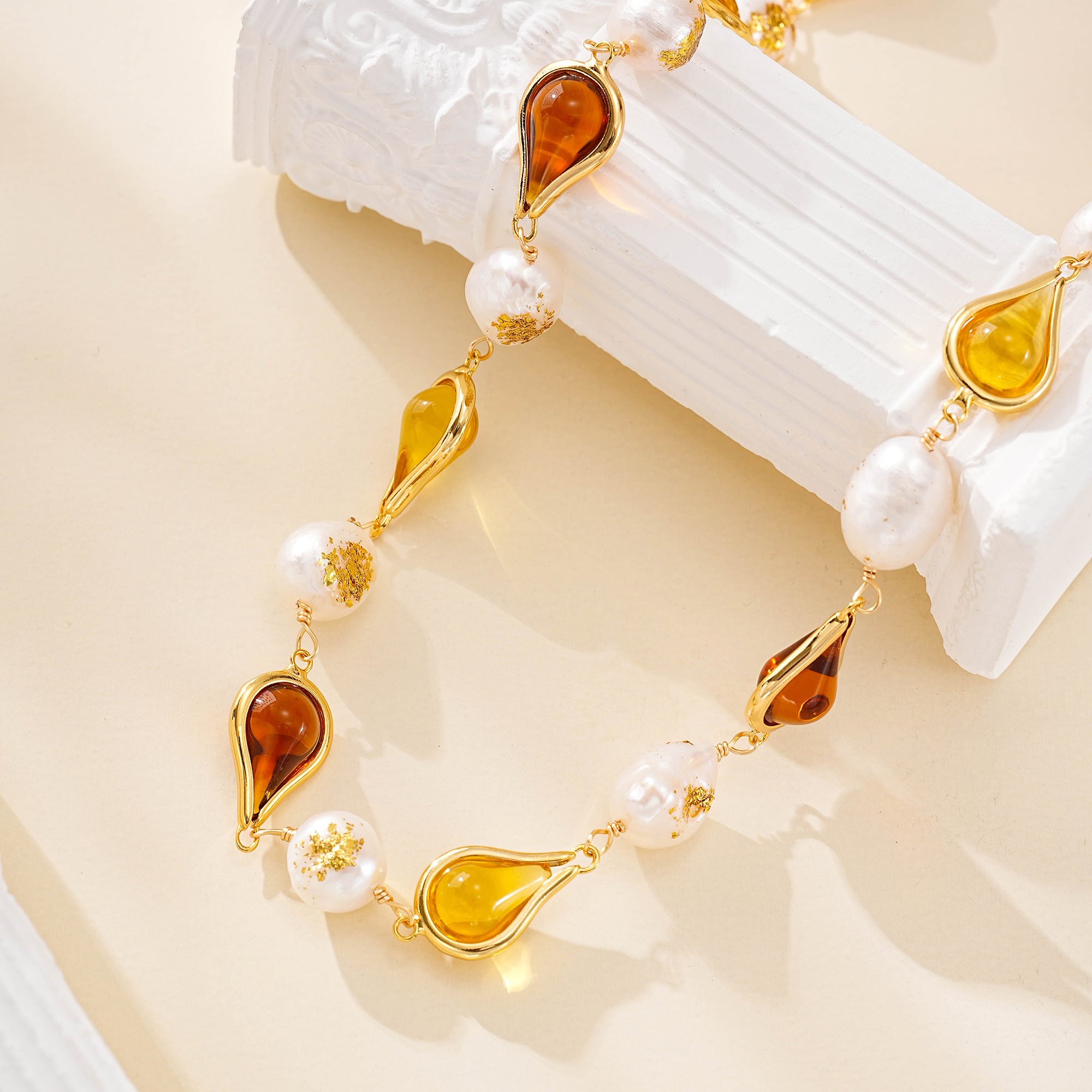 Close-up of amber-toned resin and pearl necklace