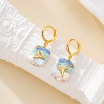 Close-up of blue and white painted pearl earrings