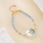 Blue beaded bracelet with painted baroque pearl centerpiece