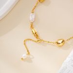 Bracelet clasp and gold-tone bead detail with pearl accent
