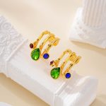Close-up of multicolor stone charms on layered hoop earrings