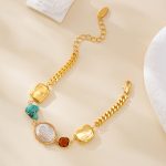 Gold-tone mixed-link bracelet laid open with turquoise and pearl accents