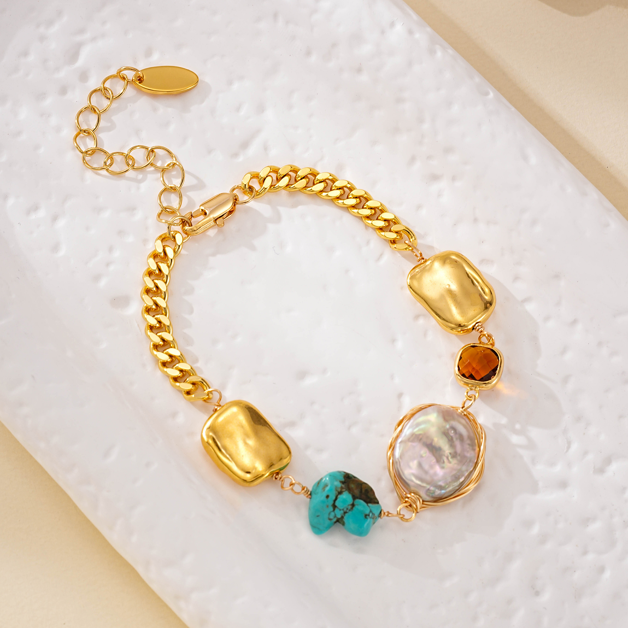 Gold-tone chain and clasp on a turquoise and pearl bracelet