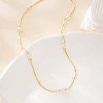 Close view of freshwater pearls along the shorter necklace