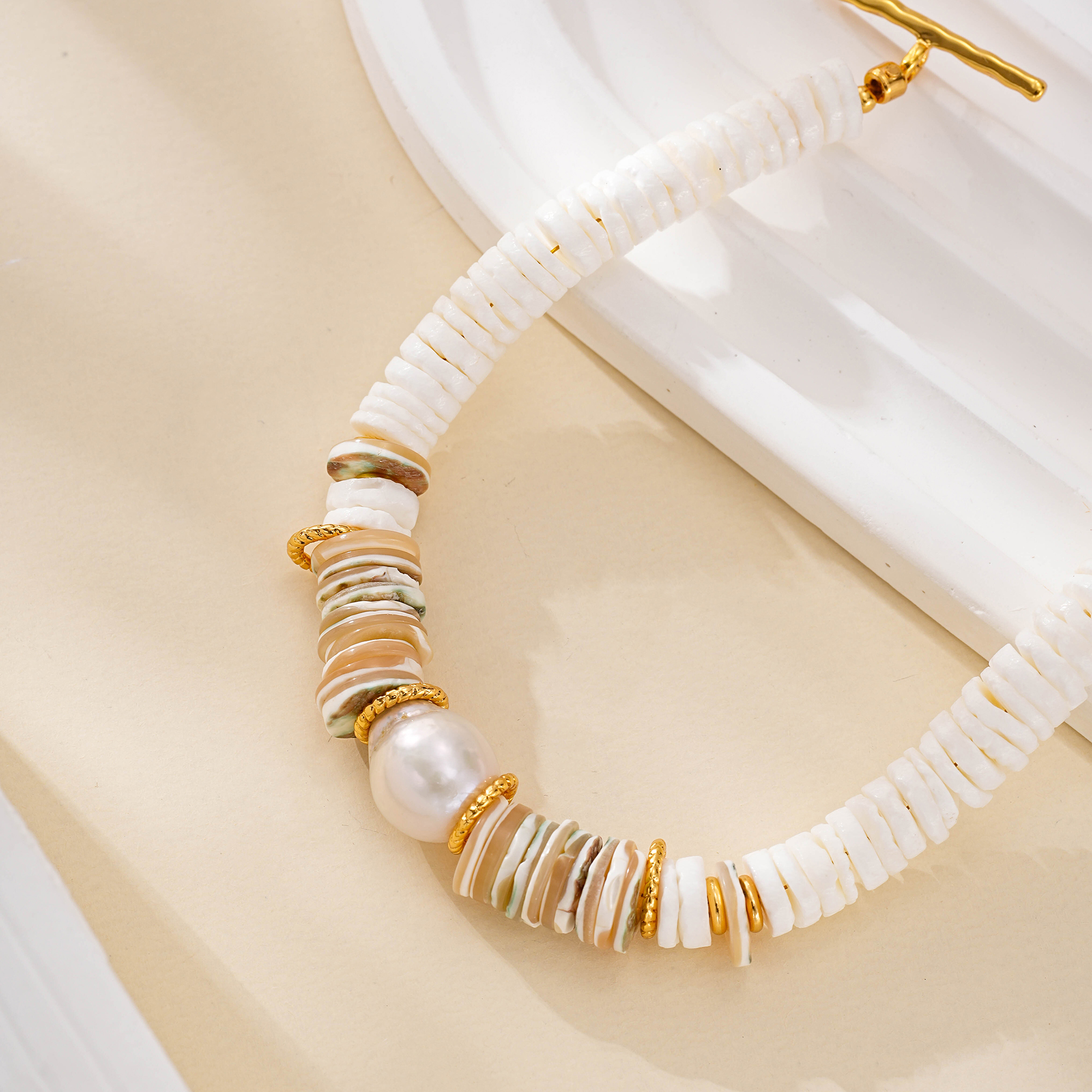 White grey and translucent shell discs with gold-tone spacers