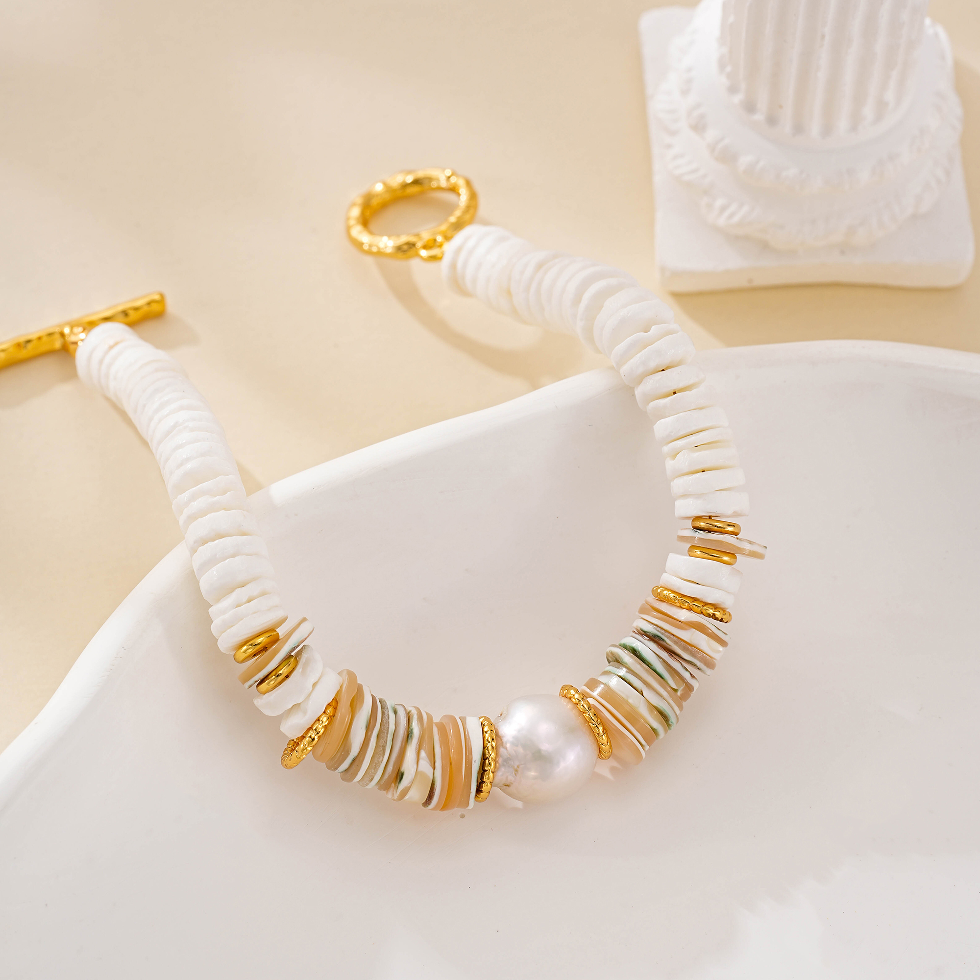 Detail of layered shell discs and freshwater pearl bracelet