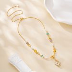 Teal violet and amber gemstone accents beside baroque pearls