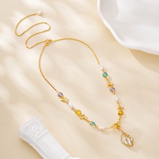 Teal violet and amber gemstone accents beside baroque pearls