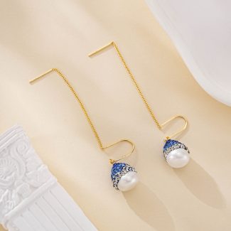 Long gold-tone threader earrings with blue accents and baroque pearls