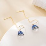 Close view of sparkling blue and clear accents above pearl drops