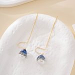 Detail of blue accented baroque pearl threader earrings
