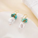 Close view of turquoise stones above irregular pearl drops