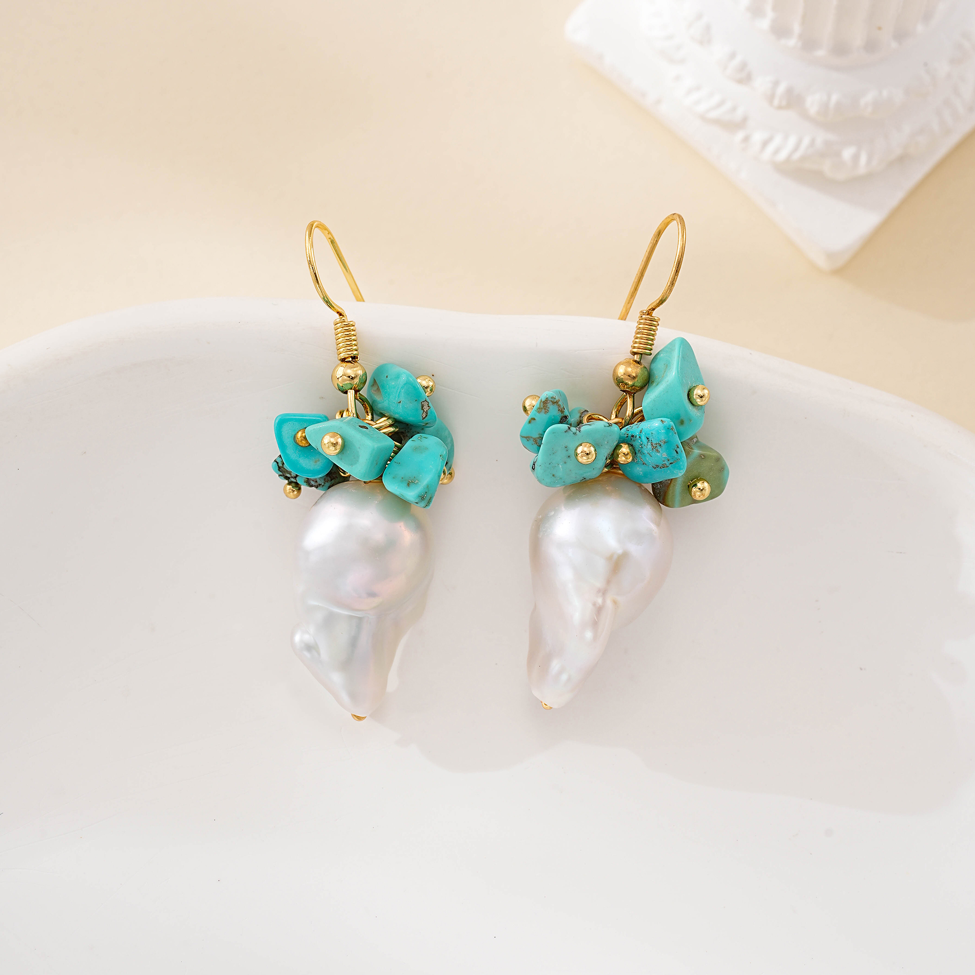Detail of organic baroque pearl shapes below turquoise stones