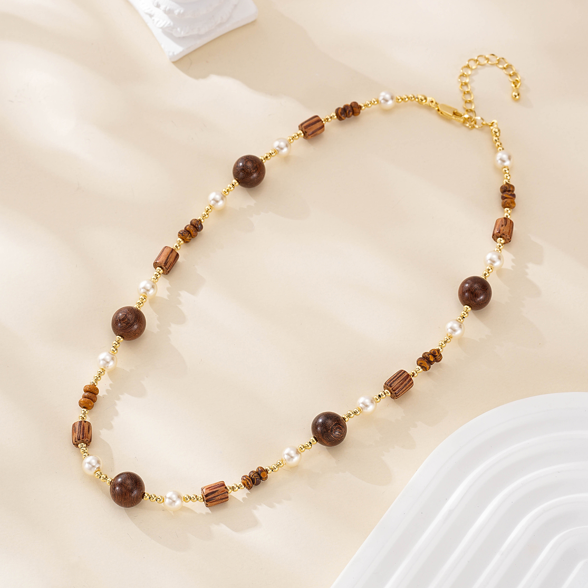 Close view of wood beads and pearls on the second necklace
