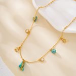 Close view of the turquoise pendant and smaller charms