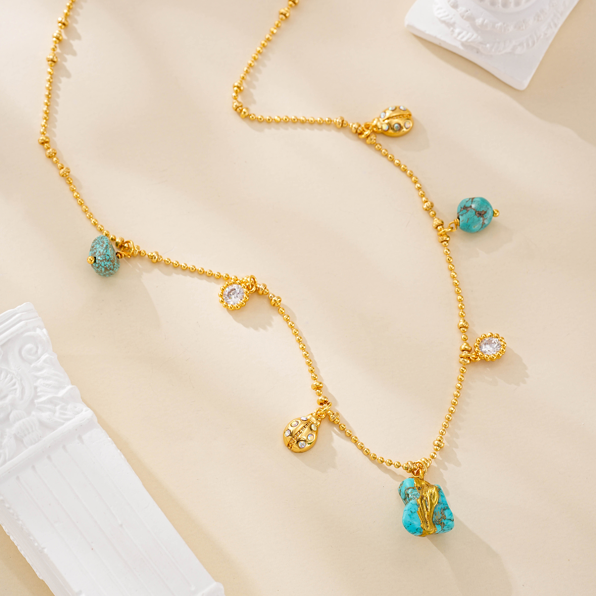 Turquoise pendant necklace laid out to show full design