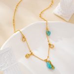 Detail of small turquoise charms along the gold-tone chain