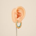 Turquoise bead C-hoop earring on an ear display