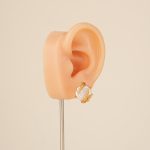 Wheat-wrapped baroque pearl stud earring on an ear display