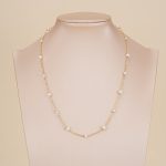 Spaced freshwater pearl necklace displayed on a bust