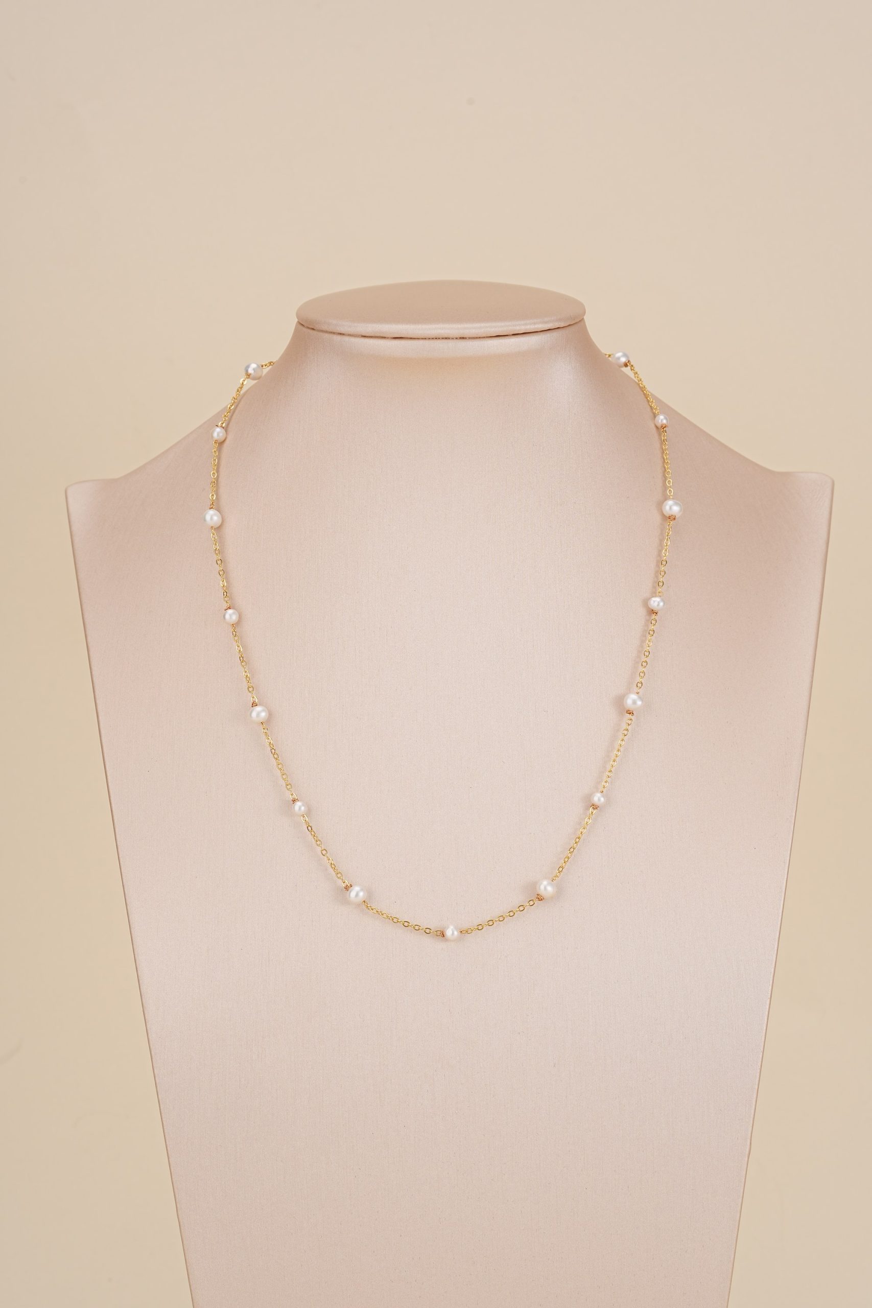Spaced freshwater pearl necklace displayed on a bust