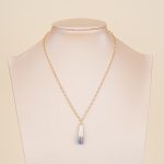 Painted pearl pendant necklace displayed on a bust